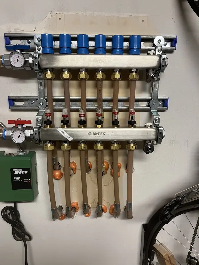 Plumber performing Water Heater Repair at a residential property in Amherst